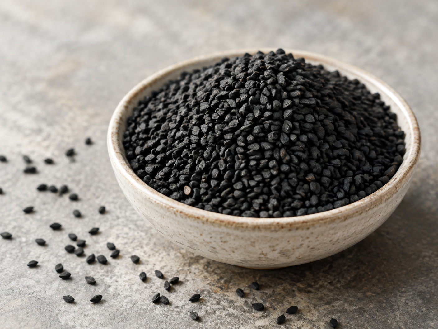 Natural black nigella seeds in a ceramic bowl